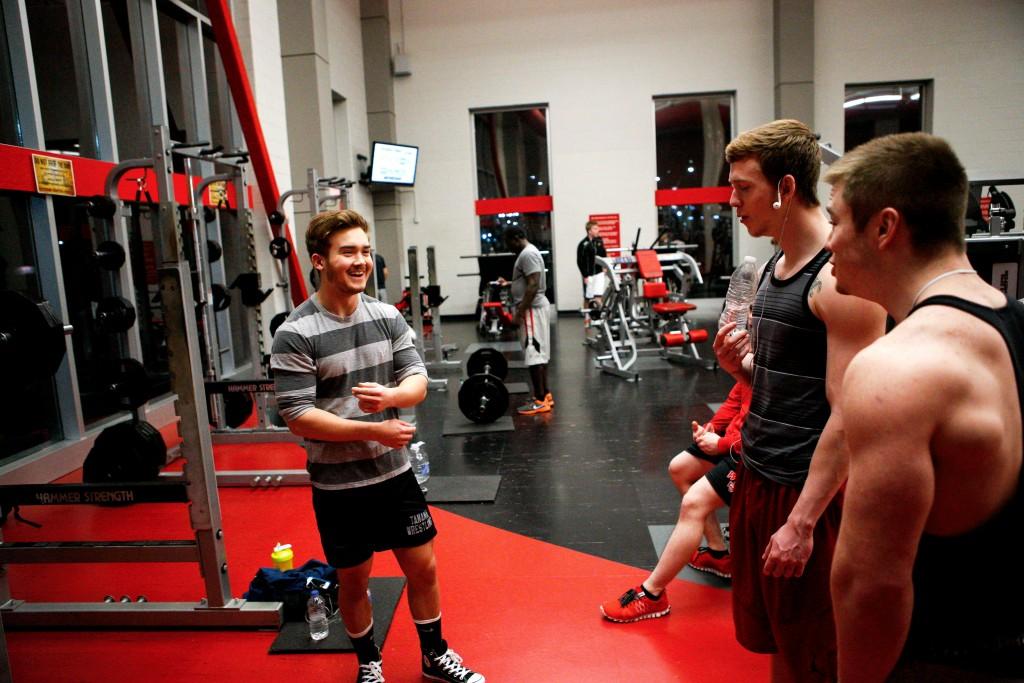 Elizabethtown sophomore Jared Coffell laughs with his friends during his workout at the Preston Center. While training, Coffell became friends with many of the regulars in the gym.