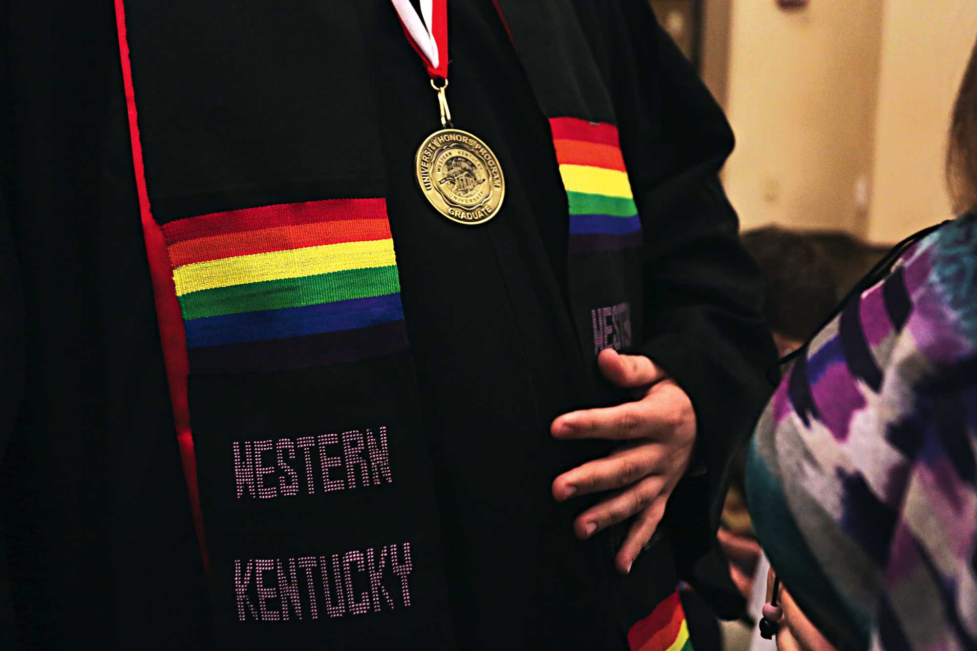 Church wears his new stole after the lavender graduation ceremony at the Augenstein Alumni Center on May 11. Each lavender graduate was given a rainbow stole during the ceremony to represent equality.