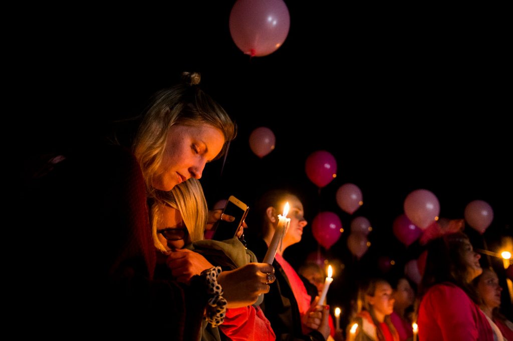 Hayley Hogback, from left, Izzy Rager, comfort each other during a vigil for Stephanie Campbell in front of the Alpha Gamma Delta house. Campbell died in a single car accident in Grayson County. (Talisman/Michael Noble Jr.)