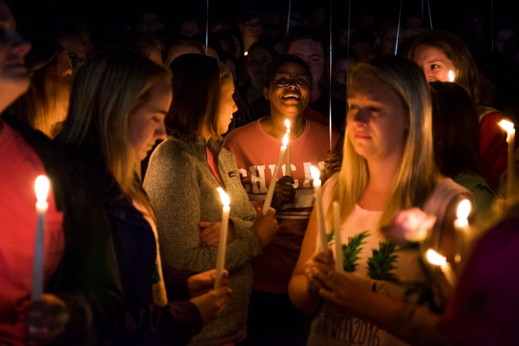 Alpha Gamma Delta alumni Rachel Shipp laughs when remembering Stephanie Campbell with friends and family at a vigil for in front of the Alpha Gamma Delta house. Campbell died in a single car accident. (Talisman/Michael Noble Jr.)