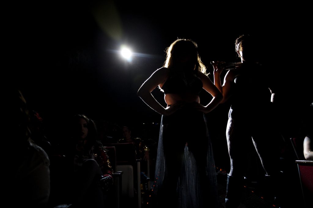 Thornsbury and Bryant, who plays Riff Raff, stand among the audience during the middle of the final scene. Because the show's energy rans largely off of audience participation, the actors often went out into the crowd and interacted with the attendees face-to-face. Photo by Skyler Ballard.