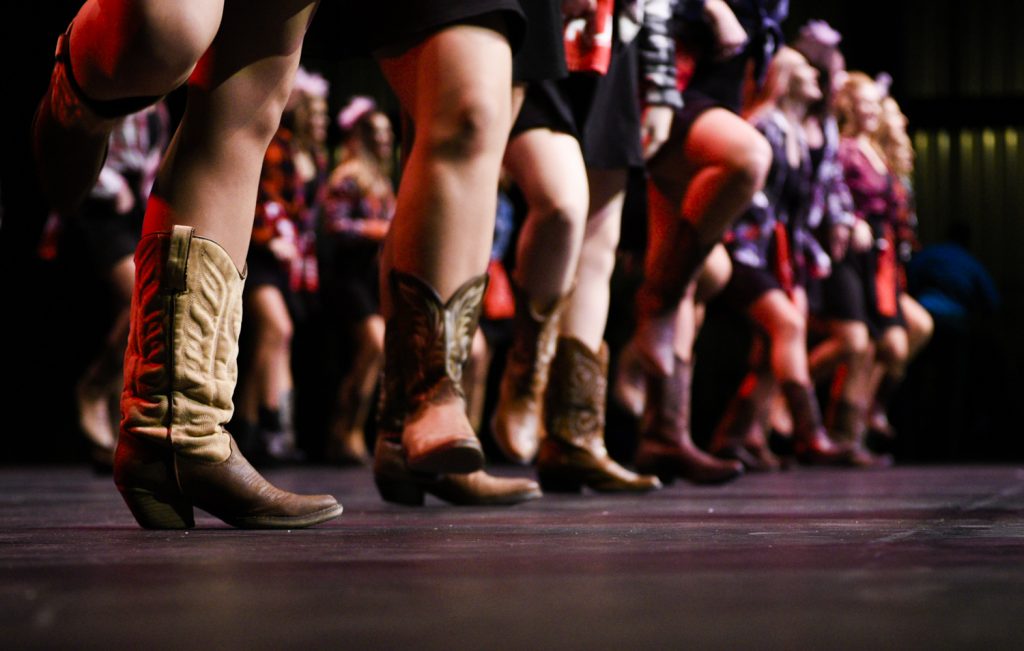 Kappa Sig members dance in cowboy boots during their “Let’s Make a Band” routine at Shenanigans, which featured dancing from several genres of music.