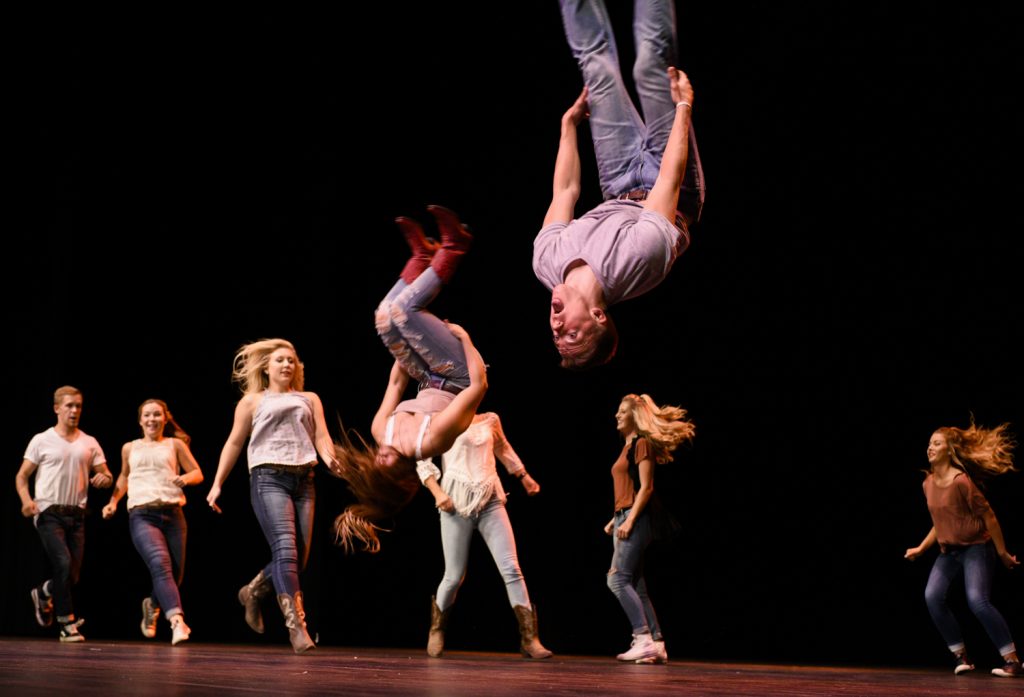 Members of Alpha Delta Pi sorority and Phi Gamma Delta fraternity do backflips for their Footloose-themed performance at SKyPAC on Oct. 4.
