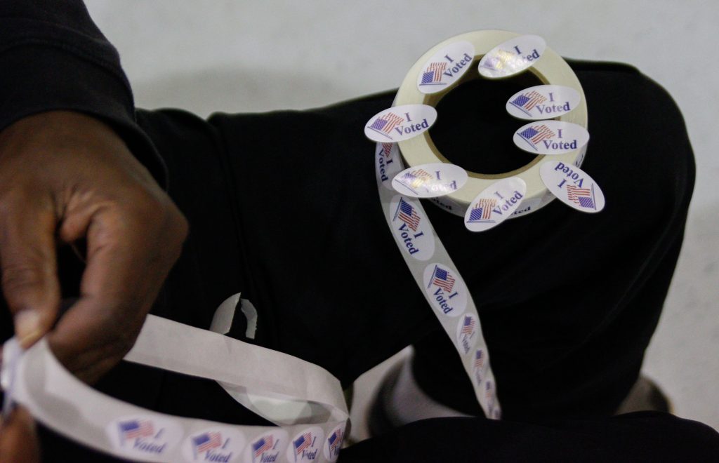 A volunteer at the Big Red precinct polling location readies "I Voted" stickers for voters as they leave the polls on Tuesday Nov. 8. Photo by Kathryn Ziesig.