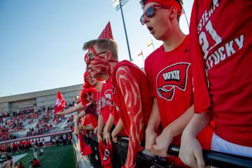 WKU Sophomore, Landon Patton, screams with his friends in the student section during the first game of the season against Sam Houston Bearkats at Houchens-Smith Stadium on Saturday, Aug. 23. (Photo by Kaitlyn Webb)
