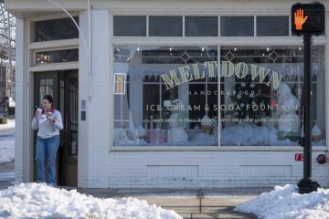 A customer leaves Meltdown Ice Cream & Soda Shop with three ice creams on Thursday, Jan. 29. (Photo by Brennan Campbell)